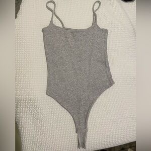 Grey bodysuit, available in size small.